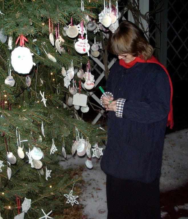 Person standing next to the tree of remembrance